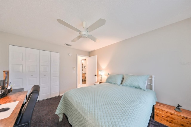 bedroom with ceiling fan, a textured ceiling, a closet, and dark carpet