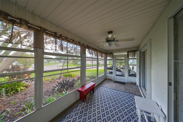 sunroom featuring ceiling fan