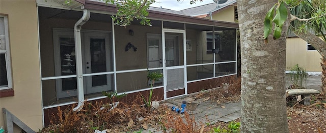 view of side of home with a sunroom