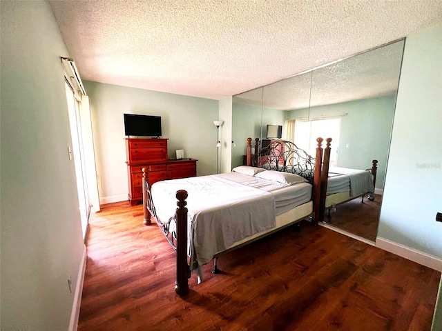 bedroom featuring a textured ceiling and hardwood / wood-style flooring