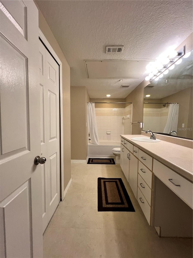 full bathroom with vanity, toilet, shower / bath combo with shower curtain, and a textured ceiling