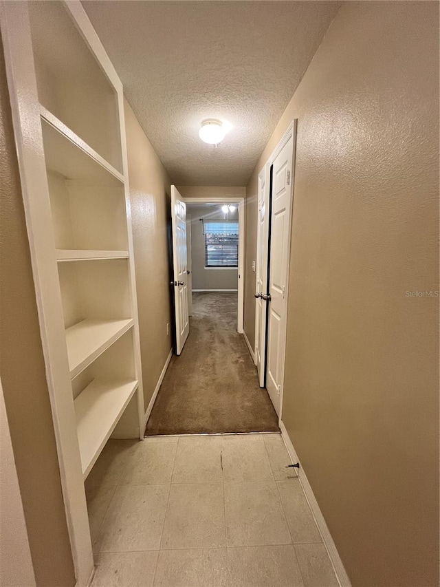 hallway featuring a textured ceiling