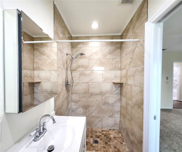 bathroom featuring vanity and a tile shower