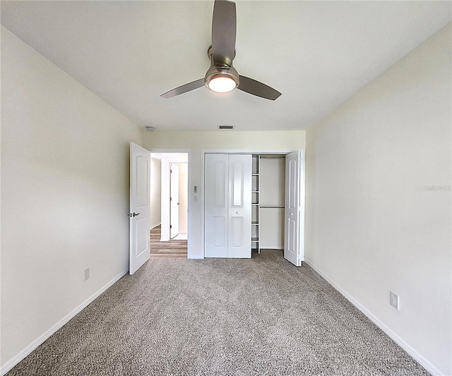 unfurnished bedroom with carpet flooring, ceiling fan, and a closet