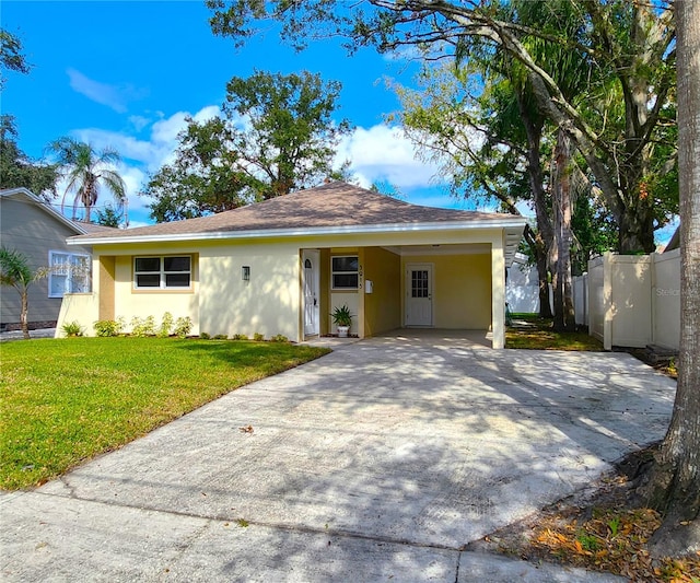 ranch-style house with a carport and a front lawn