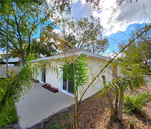 view of side of property featuring a patio area