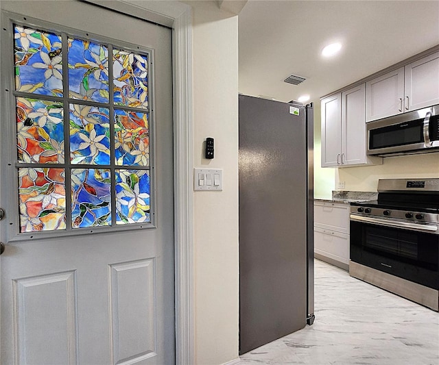 kitchen with stainless steel appliances and gray cabinetry