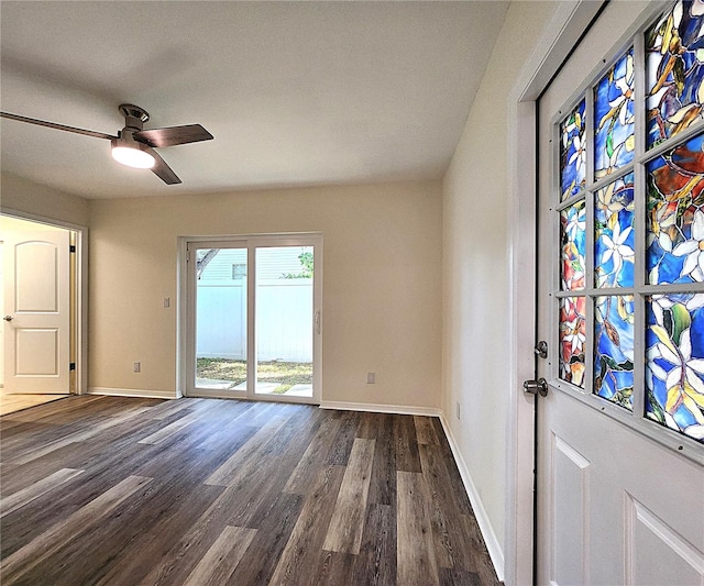 interior space featuring ceiling fan and dark wood-type flooring