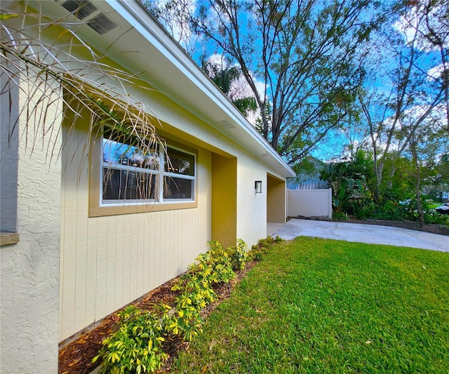 view of side of property with a yard