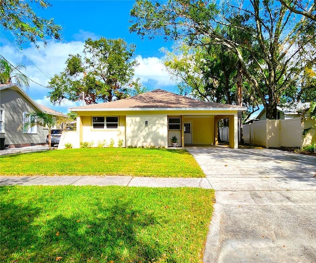 ranch-style house featuring a front lawn and a carport