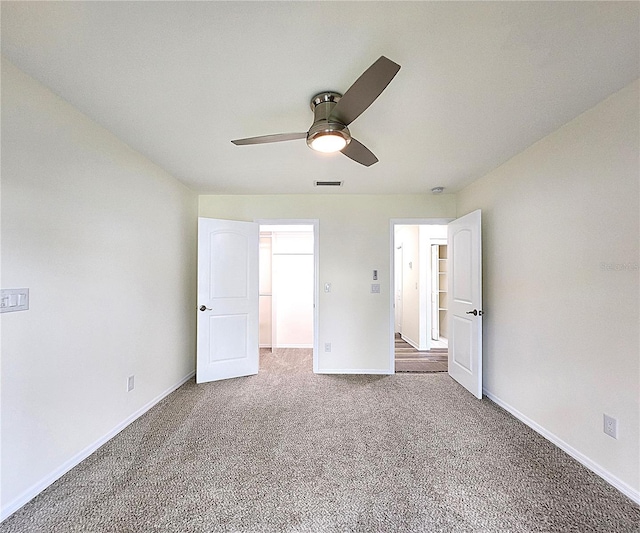 unfurnished bedroom with carpet floors and ceiling fan