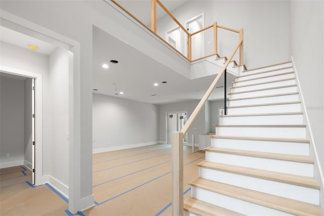 staircase with hardwood / wood-style floors