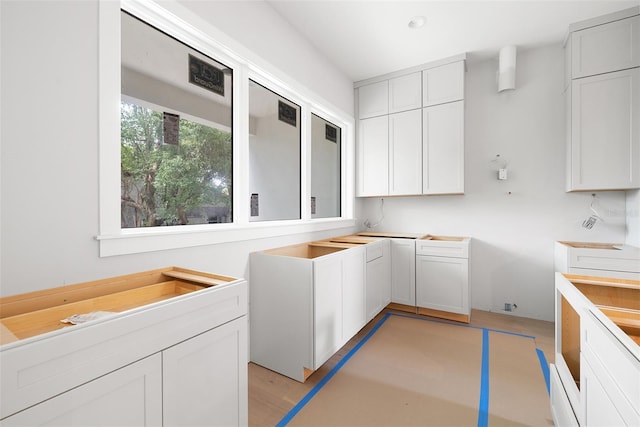 laundry area with light hardwood / wood-style flooring