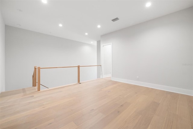 empty room with light hardwood / wood-style flooring