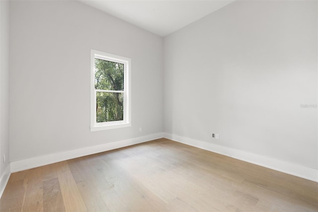 unfurnished room with hardwood / wood-style flooring