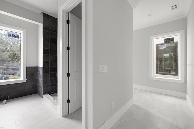 bathroom featuring a healthy amount of sunlight, tile patterned floors, tile walls, and crown molding