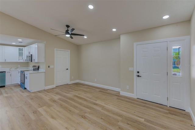 foyer with light hardwood / wood-style flooring, ceiling fan, and lofted ceiling