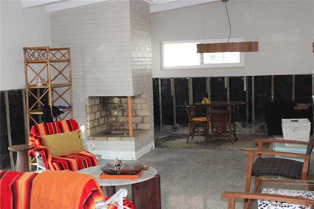 carpeted living room with vaulted ceiling with beams and a fireplace