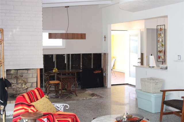 living room with a brick fireplace