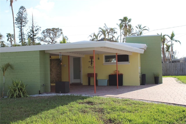 rear view of property with a yard