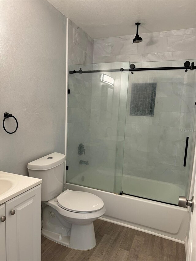 847 Hand Ave, Sarasota, FL 34232 - full bath with wood finished floors, toilet, a combined bath / shower with rainfall shower, and vanity