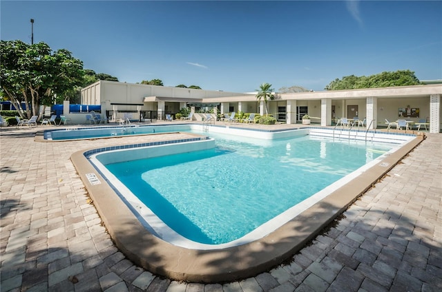 view of swimming pool featuring a patio