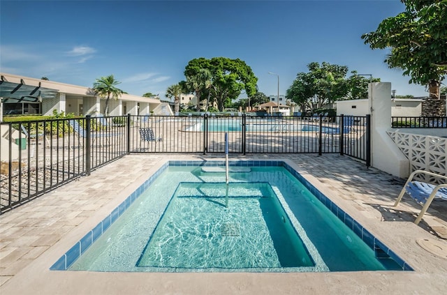 view of swimming pool with a patio area