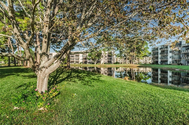 view of property's community featuring a water view and a lawn