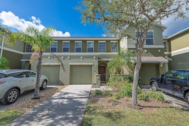 townhome / multi-family property featuring a garage