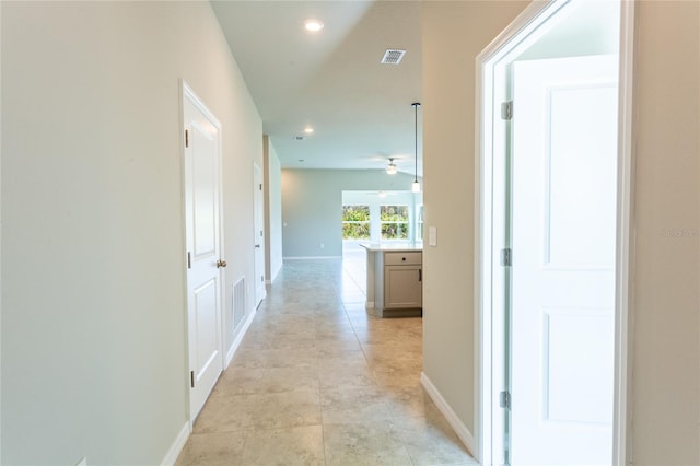 corridor featuring light tile patterned floors