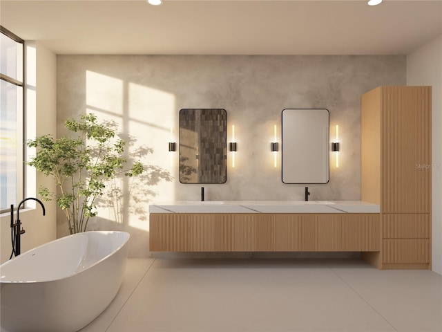 bathroom featuring a washtub, vanity, concrete flooring, and plenty of natural light