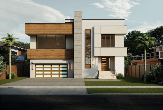 modern home featuring decorative driveway, fence, a garage, and stucco siding