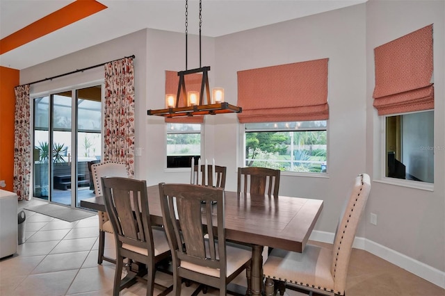 dining area featuring a notable chandelier and light tile patterned floors