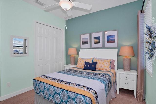 bedroom featuring light carpet, a closet, and ceiling fan