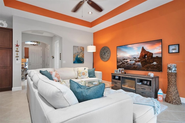 tiled living room featuring ceiling fan