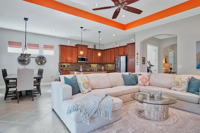 living room with light tile patterned floors and ceiling fan