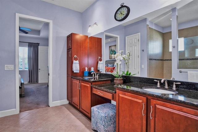 bathroom featuring tiled shower, tile patterned flooring, and vanity