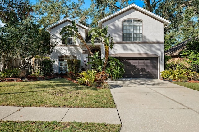 view of front of home with a garage and a front lawn