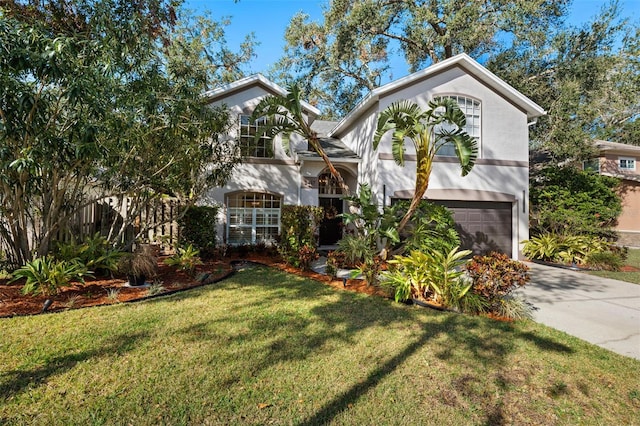 view of front of property featuring a front yard and a garage