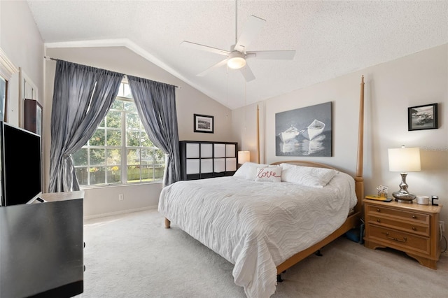 carpeted bedroom with a textured ceiling, vaulted ceiling, and ceiling fan