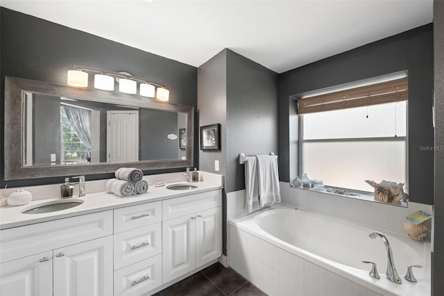 bathroom with vanity, tiled bath, and tile patterned floors