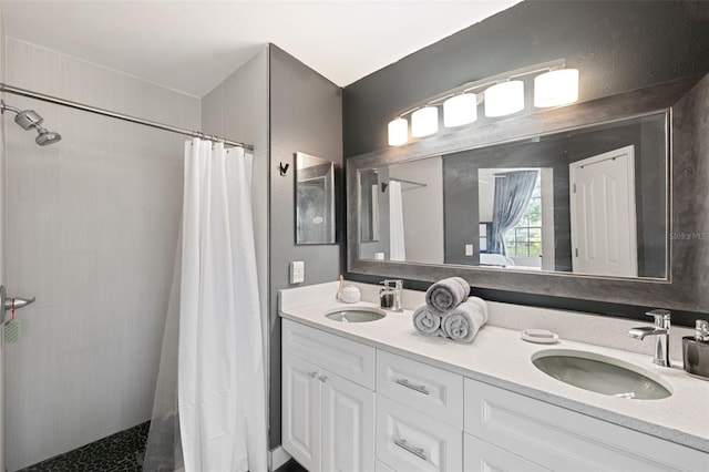 bathroom featuring a shower with curtain and vanity