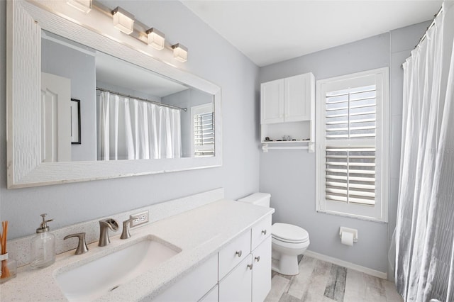 bathroom featuring hardwood / wood-style floors, vanity, and toilet