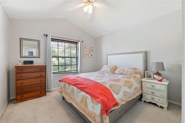 bedroom featuring a textured ceiling, ceiling fan, light carpet, and lofted ceiling