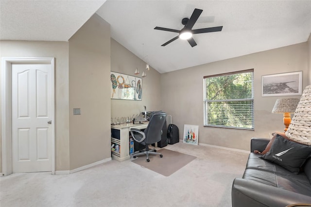 office area with carpet flooring, a textured ceiling, vaulted ceiling, and ceiling fan