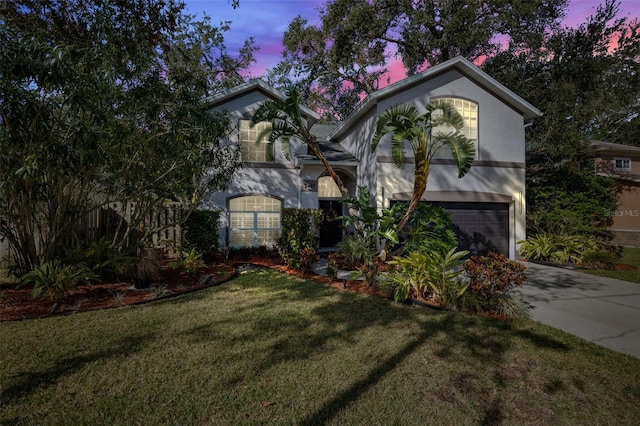 view of front of house with a lawn and a garage