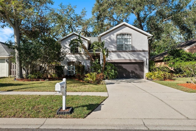 view of front facade with a garage and a front lawn