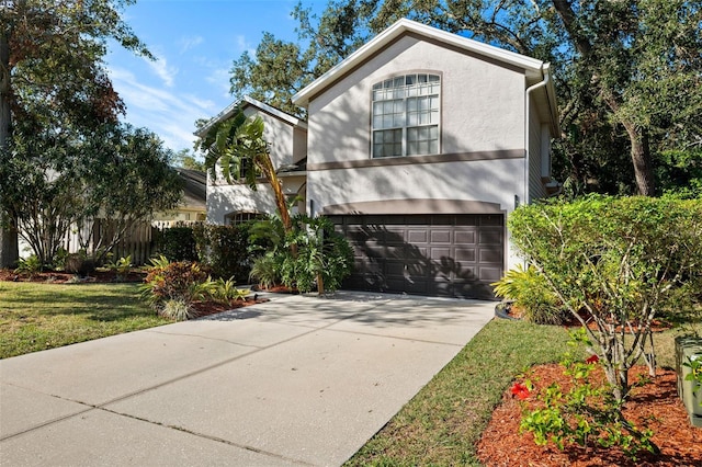 view of front of property with a front yard and a garage