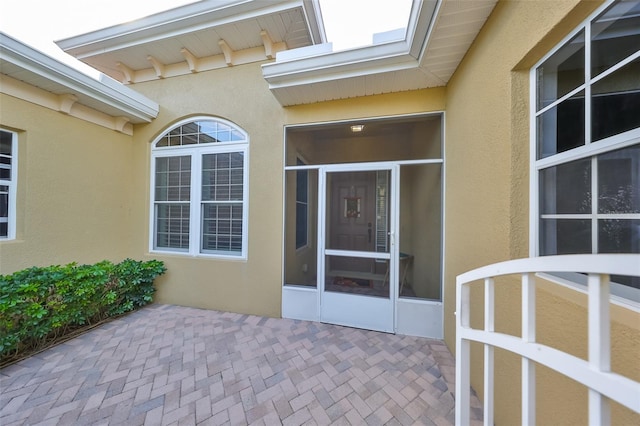 property entrance featuring a patio area