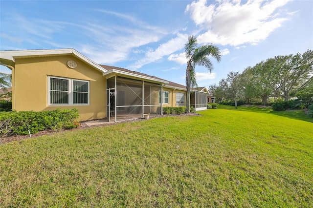 rear view of property with a lawn